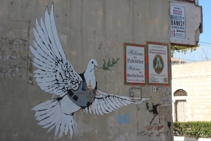 Banksy: A dove carries an olive branch in a bullet-proof vest with a target on its chest.